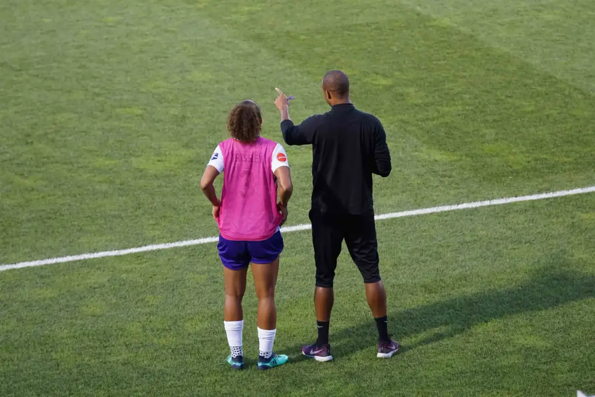 Soccer coach instructing a player